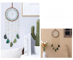 Detail of bohemian dream catcher with green agate slices and natural stone beads decor