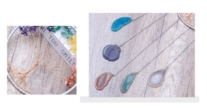 Macro detail of Tree of Life crystal ornament and various natural agate slice pendants