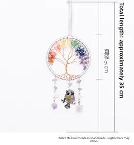 Macro detail of Tree of Life hanging ornament with colorful gemstones and owl charm