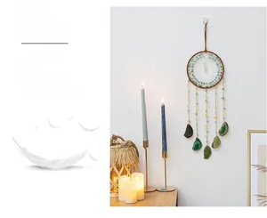 Detail of dream catcher featuring green natural stones and translucent agate slice pendant