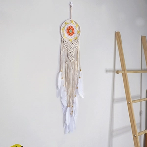 Bohemian crochet wall hanging with sunflower pattern and white feathers for home decor