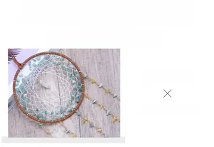 Detailed view of handmade dreamcatcher featuring green aventurine stones and woven net