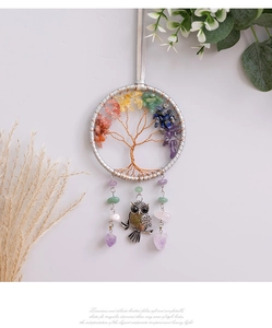 Close-up of tree of life wall hanging with colorful crystal stones and silver owl charm