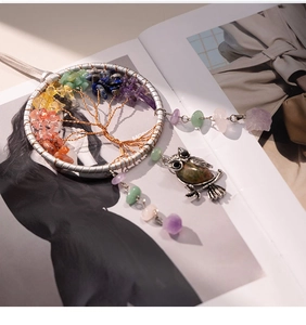 Macro detail of Tree of Life dreamcatcher with colorful gemstones and owl pendant
