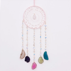 Detail of pink crystal dream catcher featuring colorful hanging agate slices and white beads