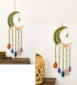 Detail of moon-shaped dream catcher with green aventurine tree of life and agate slices