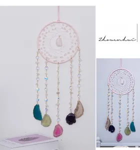 Detail of pink crystal dreamcatcher with colorful agate slices in bohemian style
