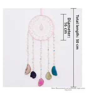 Detailed view of woven pink dream catcher with crystals and natural agate slices