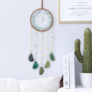 Handmade dreamcatcher with brown leather hoop, white mesh net, and green agate slices