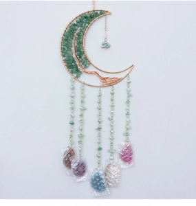 Macro detail of crescent moon suncatcher with green aventurine tree of life stones