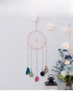 Close-up of pink quartz crystal dreamcatcher with colorful natural agate slices