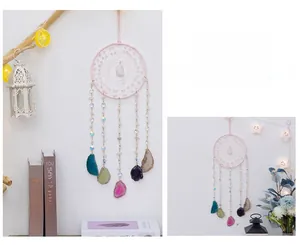 Detail of pink crystal dream catcher with colorful natural agate slices for home decor