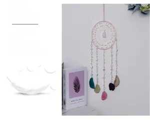 Detail of pink crystal dream catcher with hanging colorful natural agate slices
