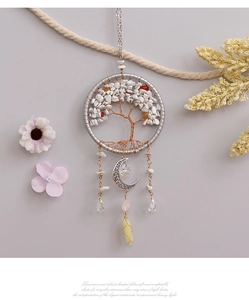 Detailed view of handmade tree of life dreamcatcher with white natural crystal stones