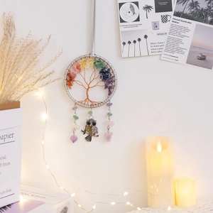 Tree of Life wall decor with natural crystals and a vintage owl charm hanging on a wall