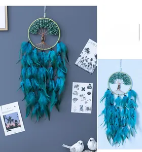 Detail of tree of life wall hanging with green gemstones and peacock blue feathers