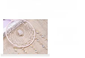 Close-up of handmade pink quartz woven dreamcatcher with crystal beads and fine mesh