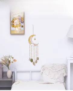 Detail of bohemian citrine moon wall hanging with natural agate slices and gold wire