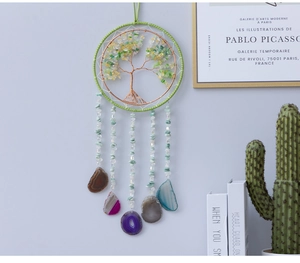 Detail of life tree wall hanging with green crystals and colorful agate slices pendant