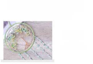 Macro shot of handmade Tree of Life wall hanging with green crystals and copper wire art
