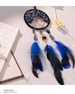 Detail of tree of life dreamcatcher with blue crystals and hanging feathers