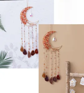 Detail of moon-shaped suncatcher with orange stones and natural agate slices