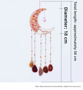 Detail of moon-shaped suncatcher with orange stones, crystal ball, and agate slices