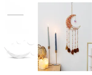 Close-up of golden moon suncatcher with red crystals and natural agate slices decor