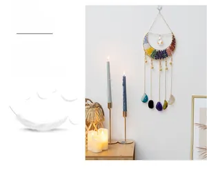 Detail of moon-shaped dream catcher with chakra stones and colorful agate slices hanging