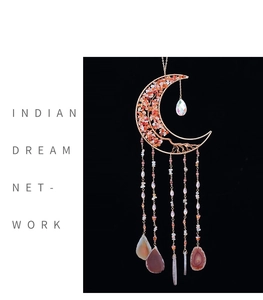 Detail of moon suncatcher with golden wire frame, red stones and agate pendants