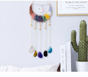 Detail view of crescent moon wall hanging with 7 chakra crystals and agate slices
