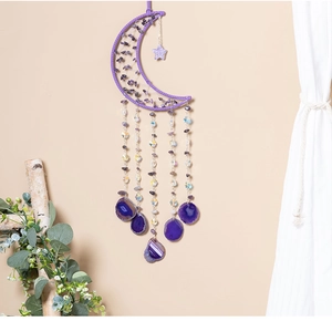Macro detail of crescent moon dreamcatcher with purple amethyst stones and agate slices