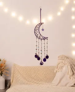 Detailed shot of purple moon-shaped dream catcher with natural agate slices and crystals