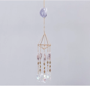 Detailed view of amethyst suncatcher with gold geometric frame and iridescent crystal drops