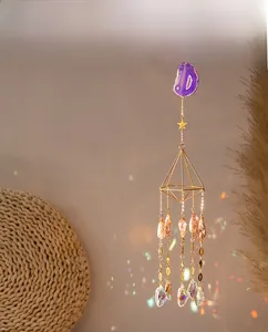 Detail of purple agate crystal suncatcher showing geometric gold frame and light refraction