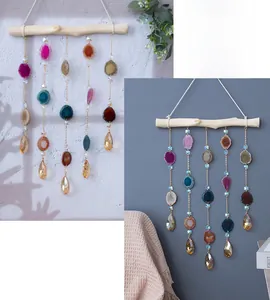 Detail of natural agate slices wall hanging with metal chains and crystal pendants