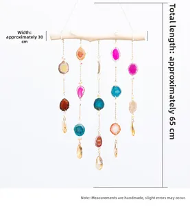 Detail of natural agate slices wall hanging with faceted crystal pendants and wood bar