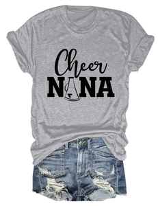 Flat lay of a grey crew neck t-shirt with graphic print and blue denim shorts
