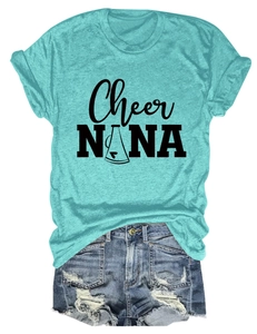 Flat lay of a teal crew neck t-shirt with Cheer NANA print and distressed denim shorts
