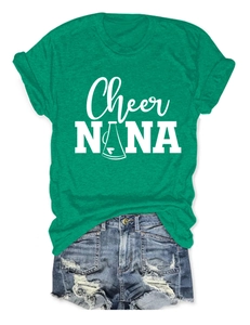 Flat lay of green cotton crewneck T-shirt with Cheer NANA print and denim shorts