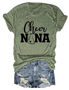 Flat lay of a green crewneck T-shirt and distressed blue denim shorts summer outfit