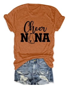 Close-up of orange crew neck T-shirt with black graphic print and denim shorts set