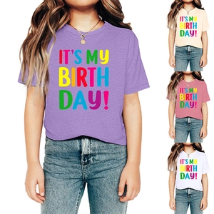 Detail view of girl birthday t-shirts in purple, apricot, pink and white colors