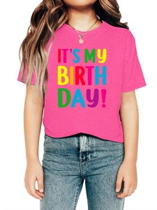 Detailed shot of vibrant hot pink kids birthday t-shirt with colorful printed slogan