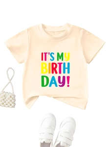 Detail of kids birthday t-shirt with colorful text print and matching accessories