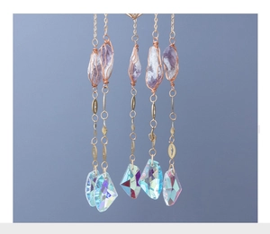 Macro view of crystal suncatcher featuring amethyst stones and faceted rainbow prisms