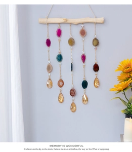 Detail of bohemian wall hanging with natural agate slices and crystals on wood