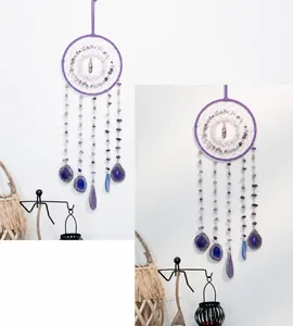 Detail of purple amethyst crystal dream catcher with natural agate slices and woven ring