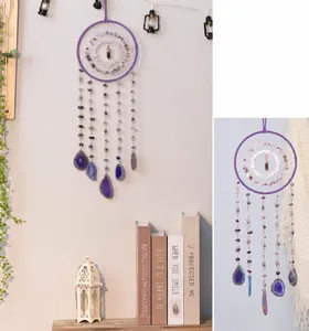 Detail of purple crystal dream catcher with amethyst fragments and agate slice pendants