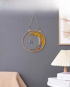 Macro detail of moon-shaped Tree of Life wall hanging with crystals and prisms